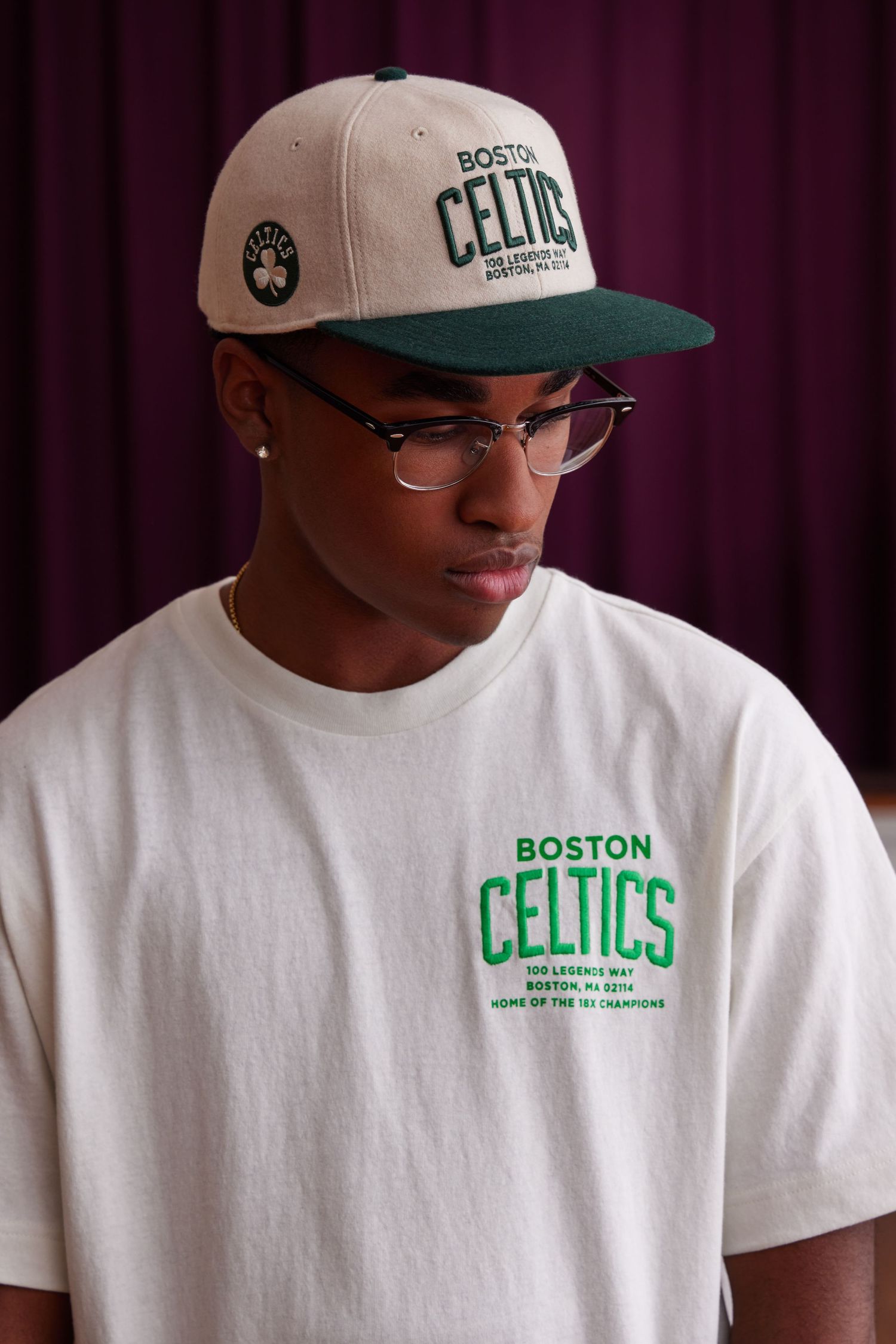 A series of photos showing white Boston Celtics t-shirts and hats with green team branding and logos.