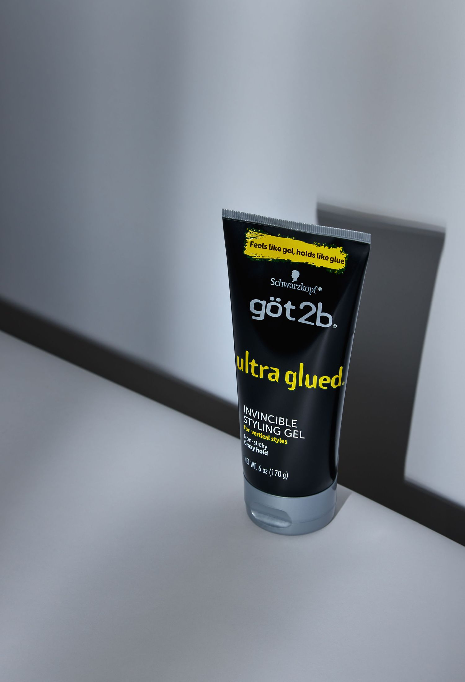 Hair styling product container labeled 'got2b ultra glued' shown from different angles against a gray background.