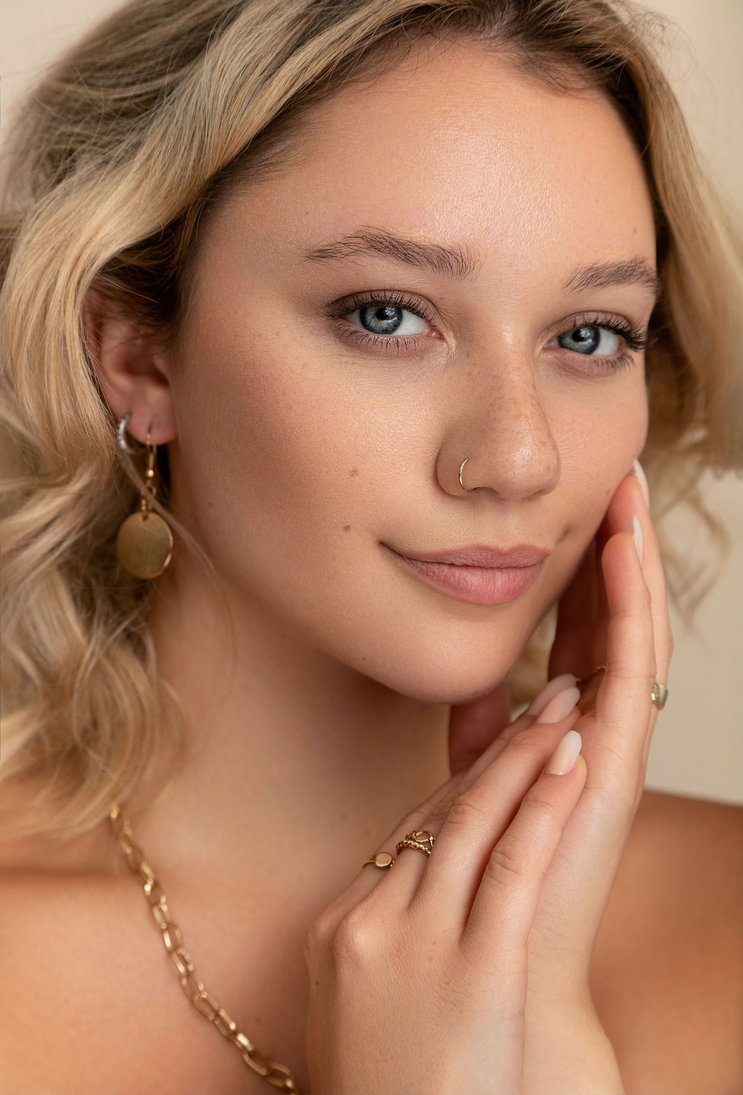 Close-up portrait series showing delicate jewelry details including nose ring, earrings and gold chain necklace.