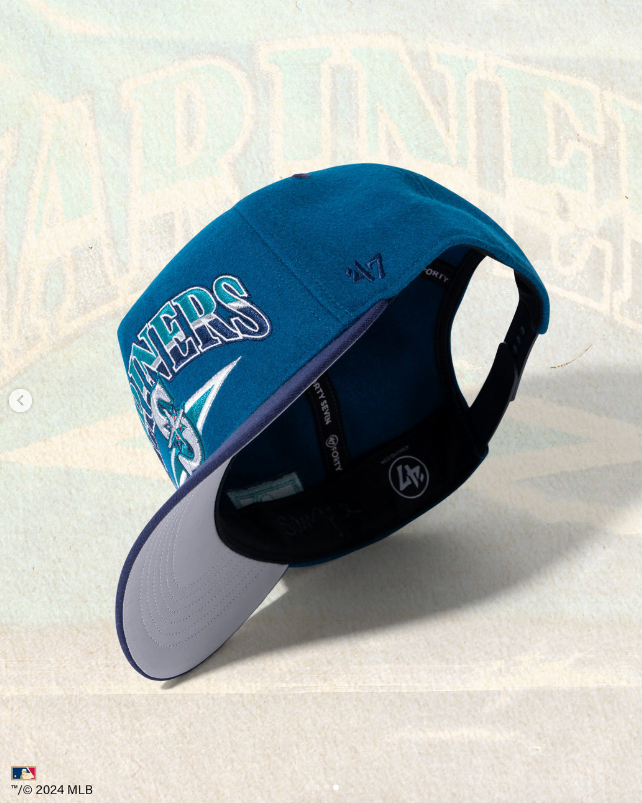 A navy blue baseball cap with 'MLB' branding shown from multiple angles displaying its curved brim and adjustable design.