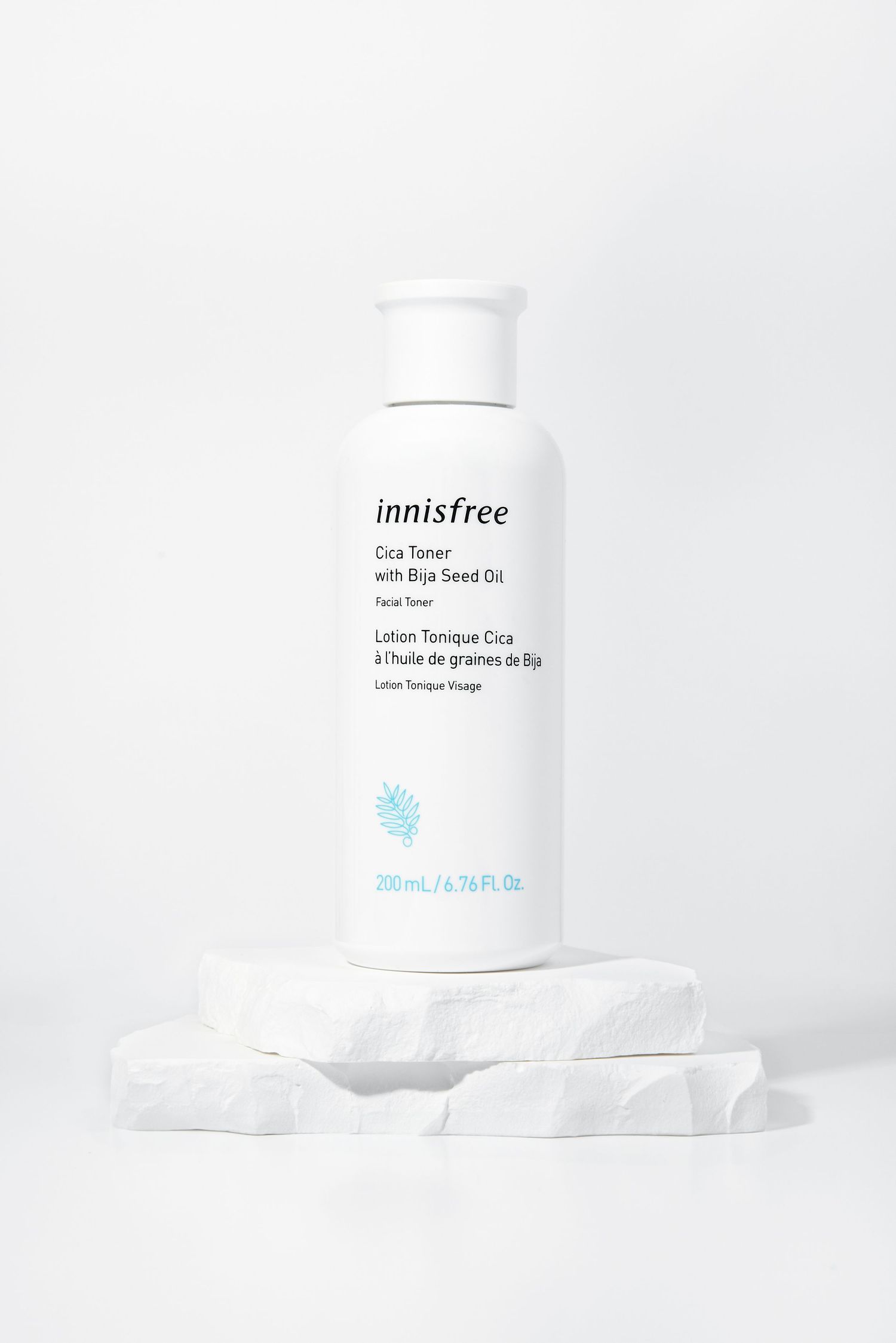 White Innisfree skincare product bottle on clean white background with soft shadows.