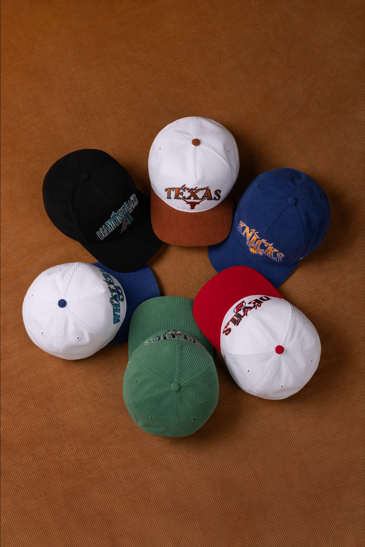 A sequence of baseball caps in various colors arranged on a brown background showing different positions and angles.