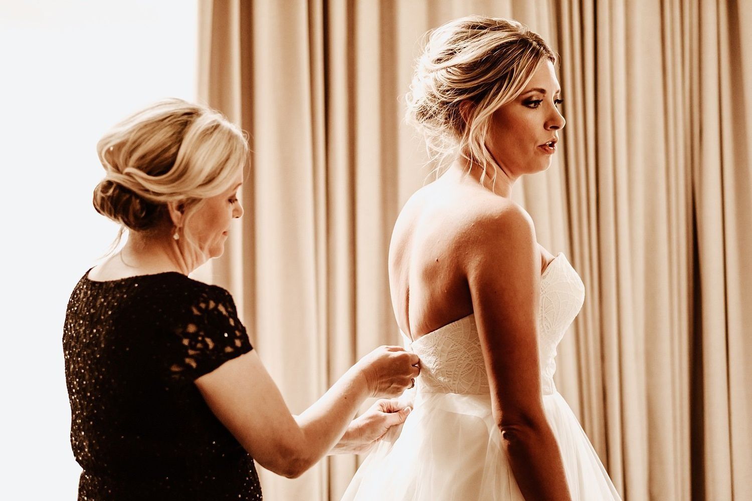 Shannon’s mother helping with the final wedding dress details
