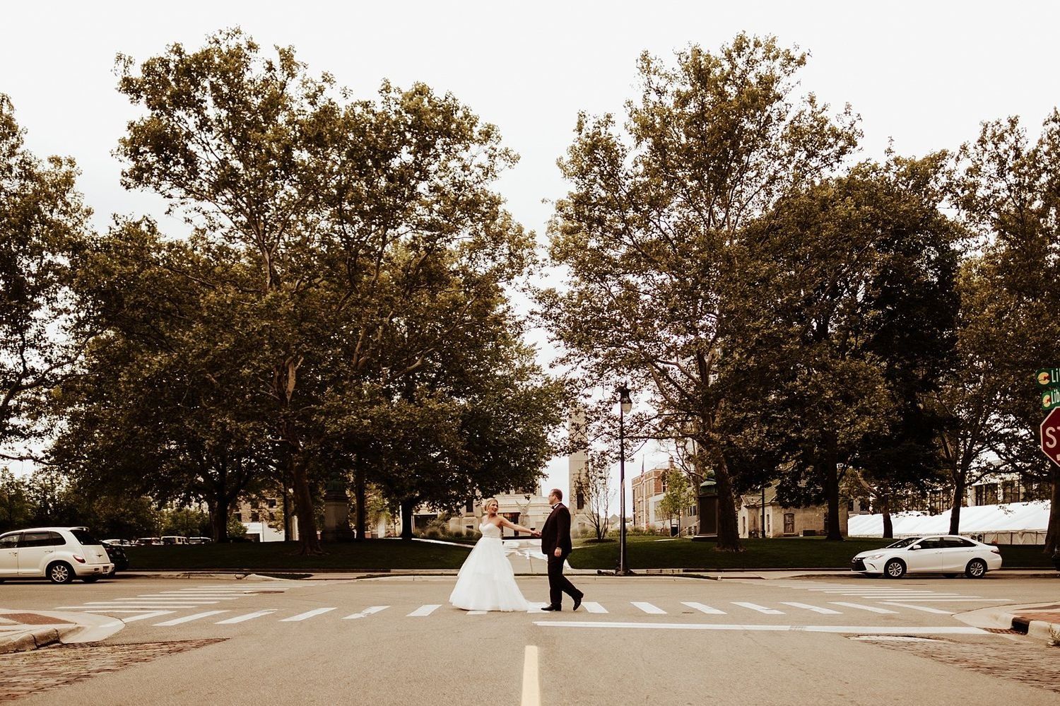 Shannon and Karel holding hands while crossing a downtown Grand Rapids street.