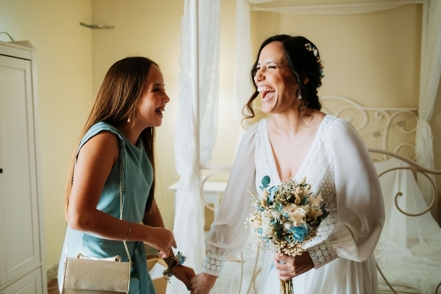 Wedding preparation scene with bridesmaids in sage green dresses helping the bride get ready.