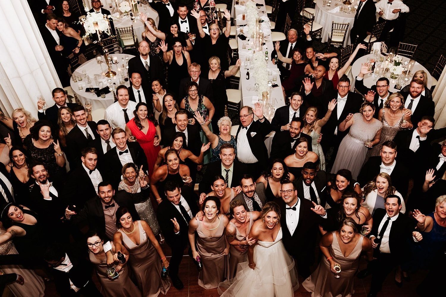 Epic aerial group photo of all wedding guests waving to photographer Roberto Pecino at The Ballroom at McKay