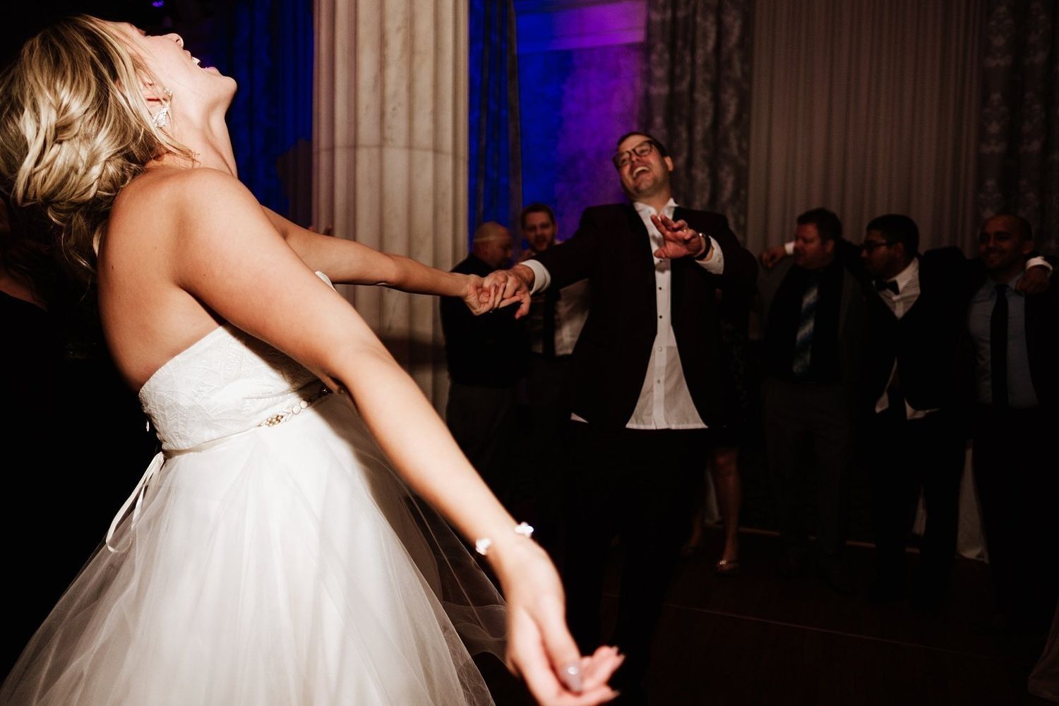 High-energy guest performance on the dance floor during a hip-hop wedding set in Grand Rapids