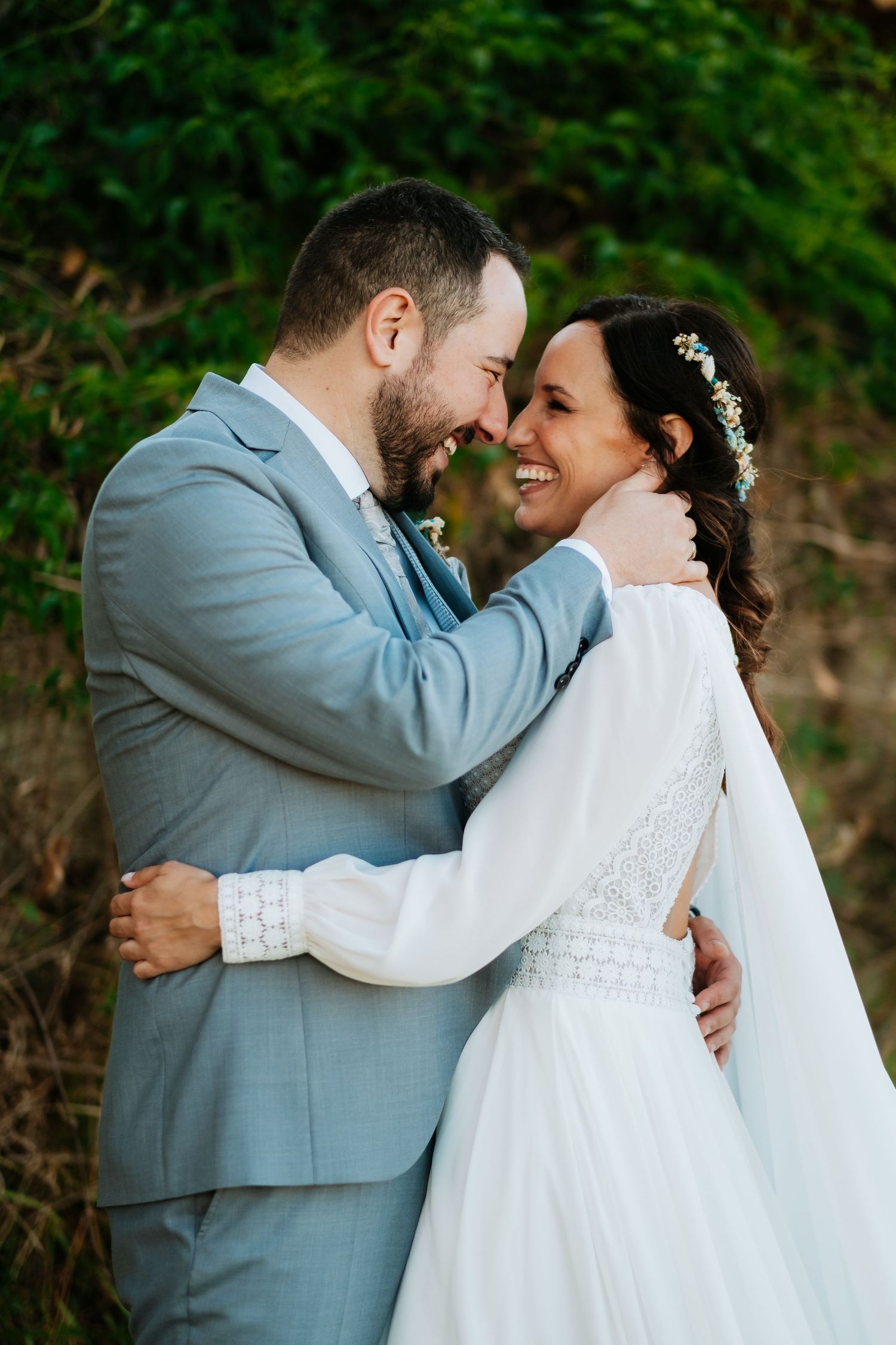Intimate wedding portraits showing tender moments between newlyweds against a natural backdrop.