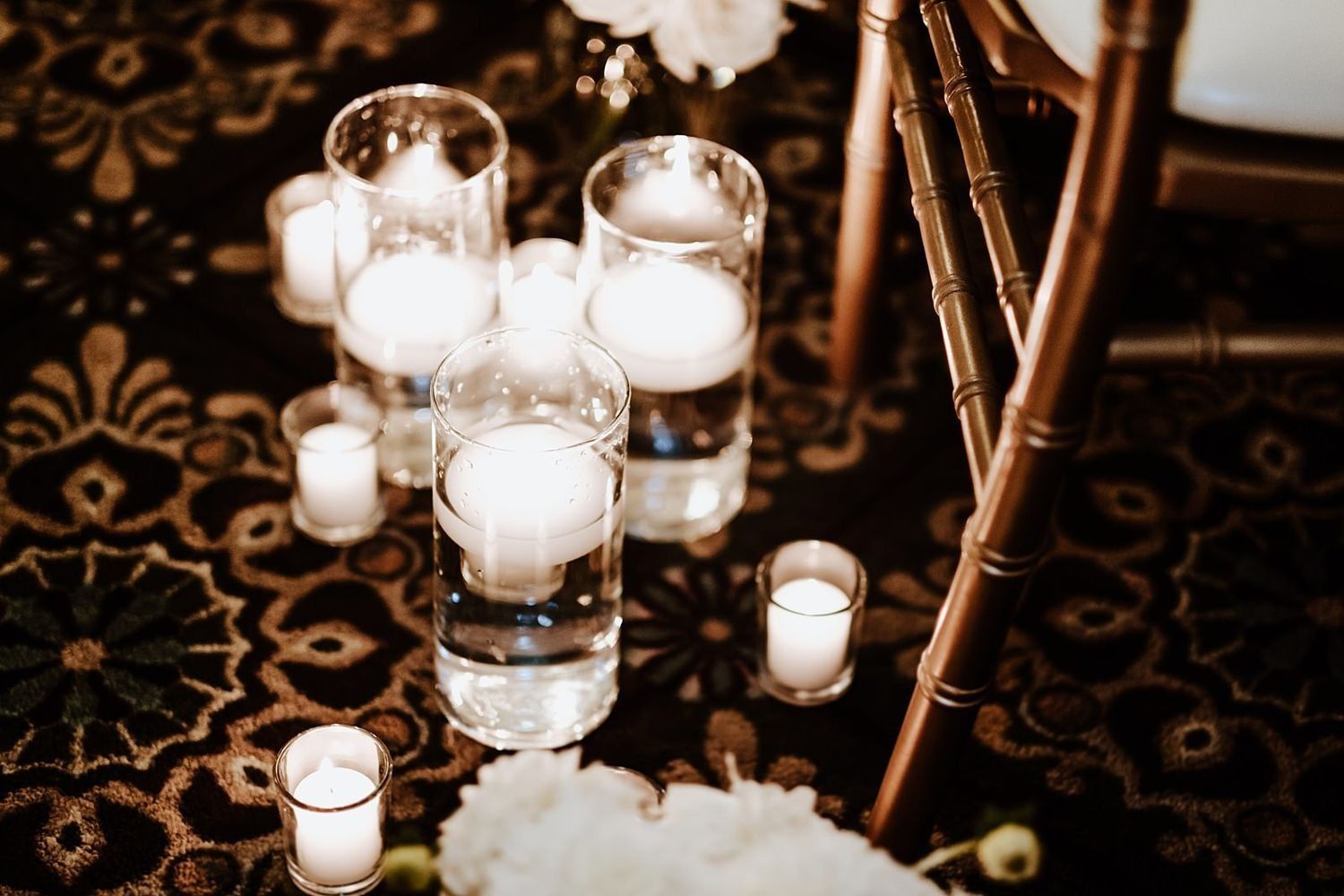 Romantic wedding aisle decor with warm candles on the carpet at McKay Ballroom