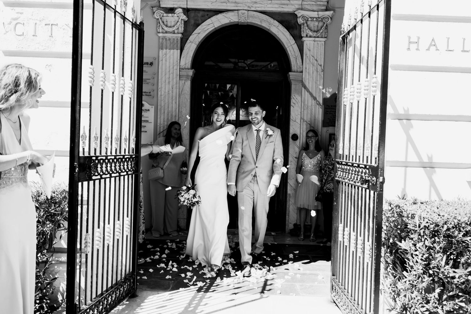 Black and white photography newlyweds exiting Gibraltar Civil Registry office just married