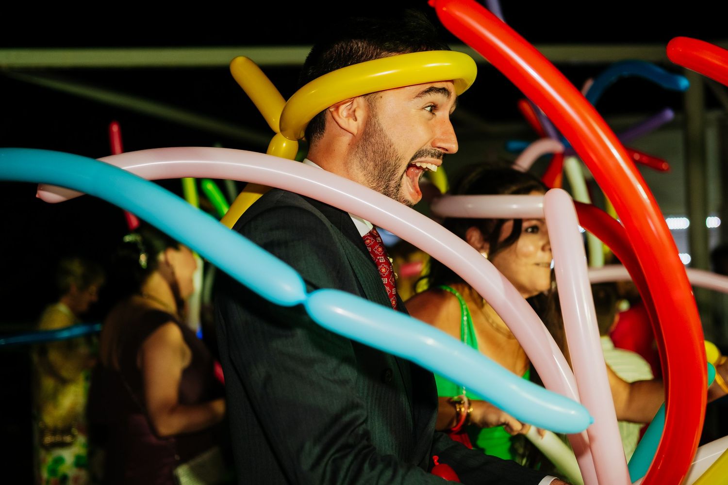 Colorful glowing foam noodles create a festive atmosphere at a nighttime party or celebration.