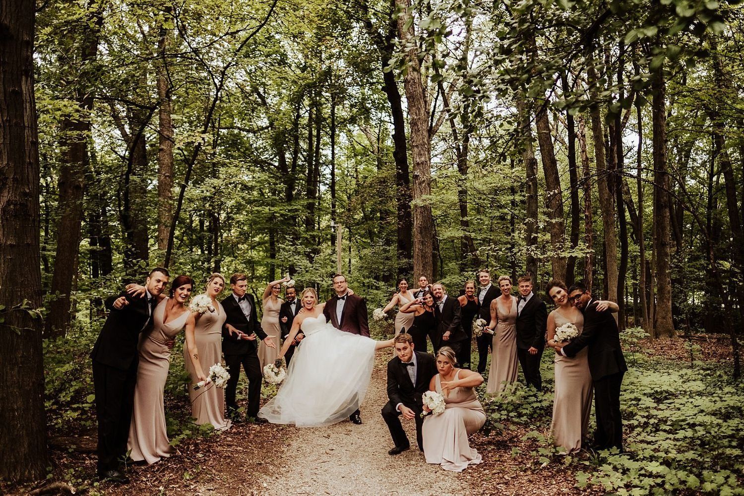 Candid wedding party portrait of Shannon, Karel, and their bridesmaids and groomsmen in a Michigan garden