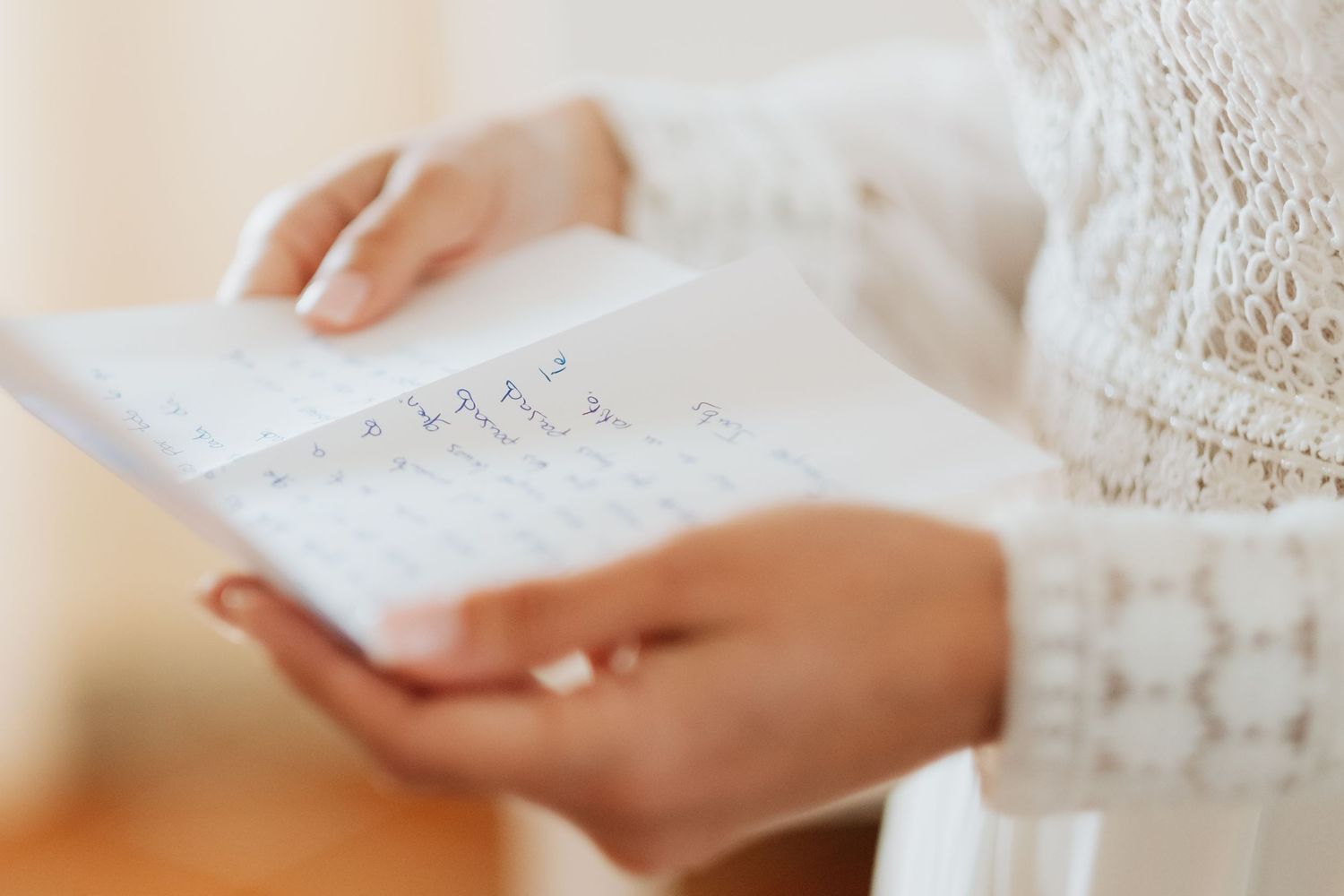 Close-up view of hands holding white paper documents while working at a desk, Roberto Pecino fotografo en Soto de Roma
