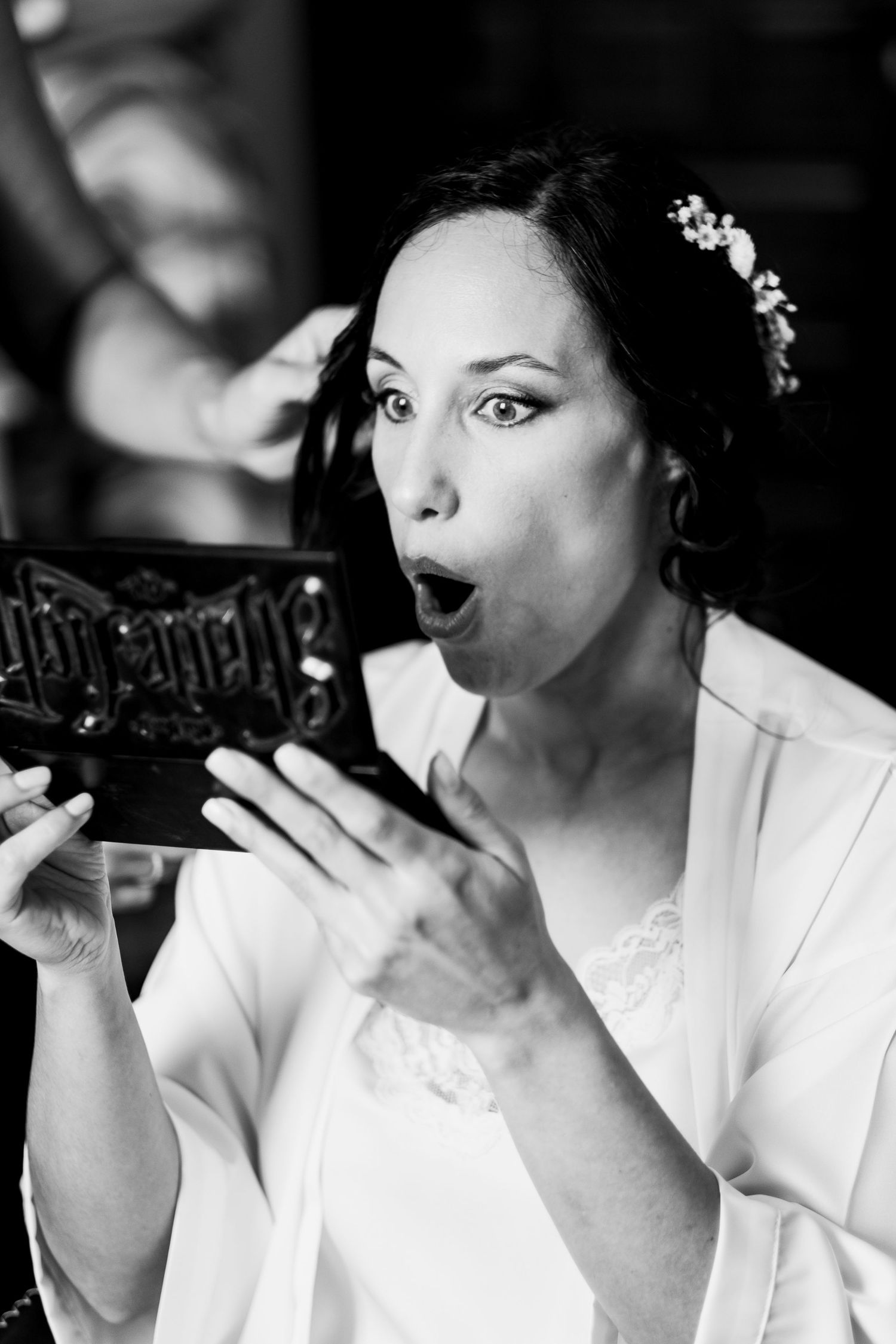 Series of black and white photos showing someone blowing into a decorative glass bottle.
