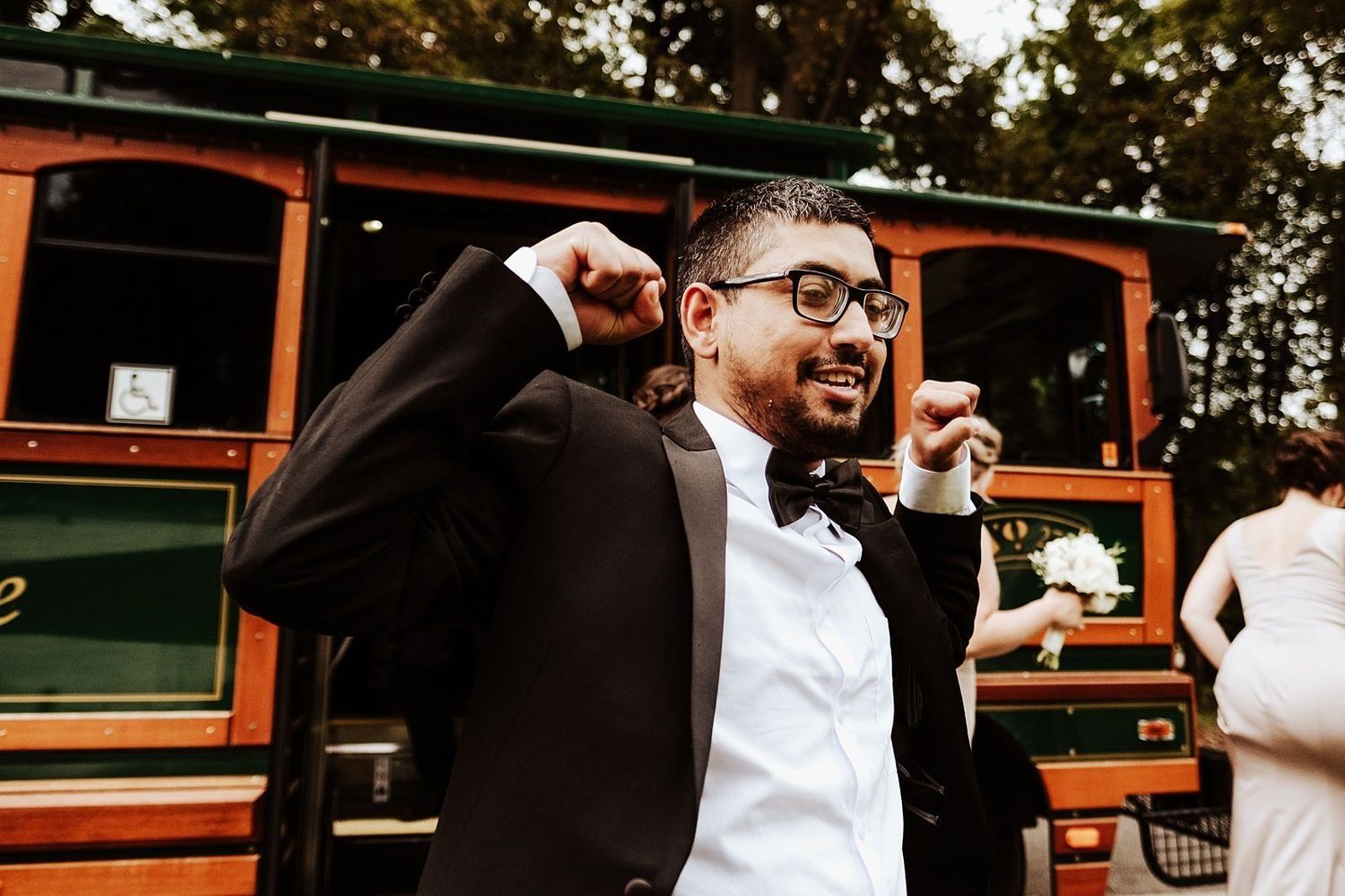 Excited wedding guest cheering during Shannon and Karel's city portrait session