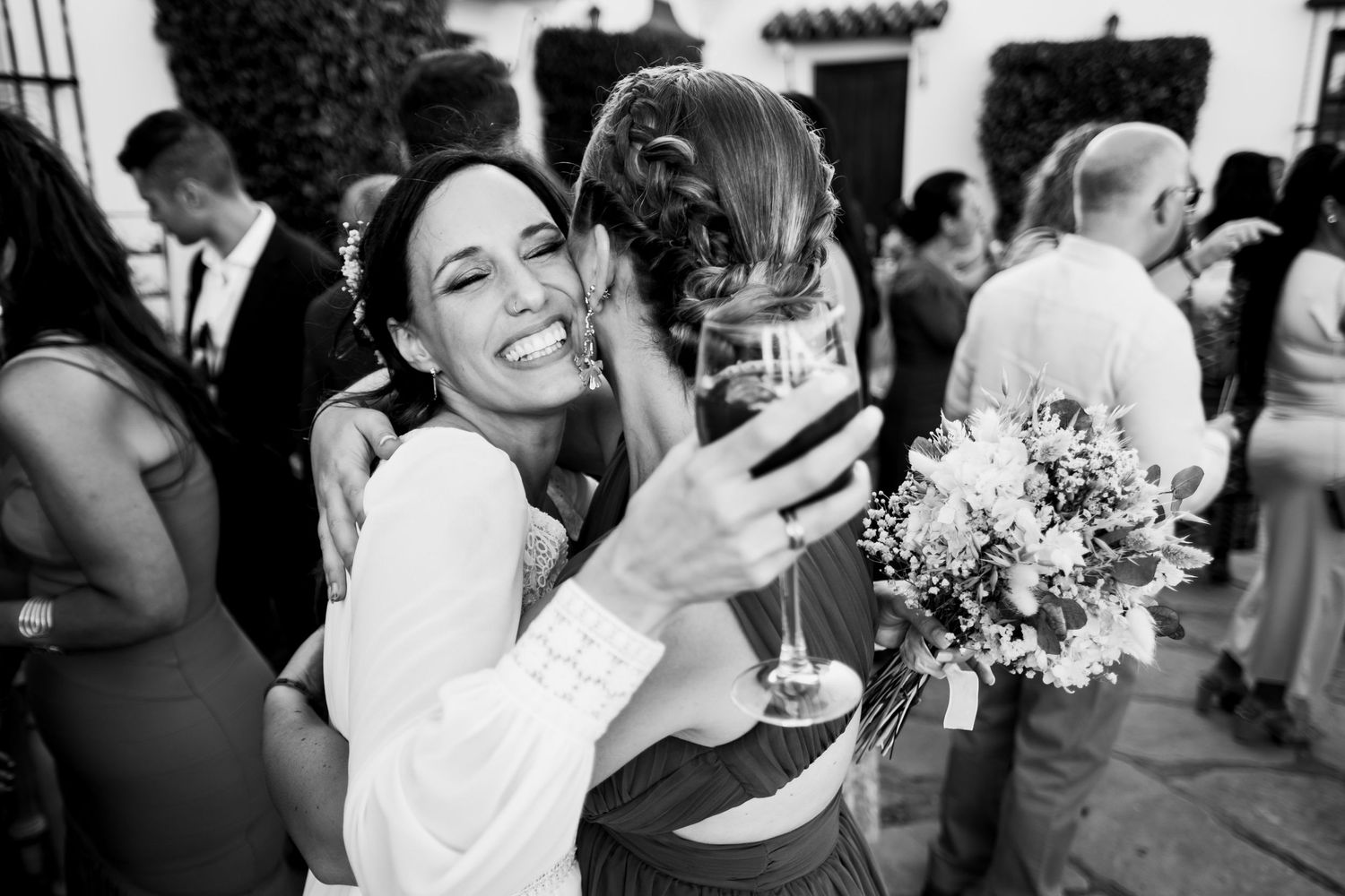 Black and white photos showing joyful wedding reception celebrations with guests.