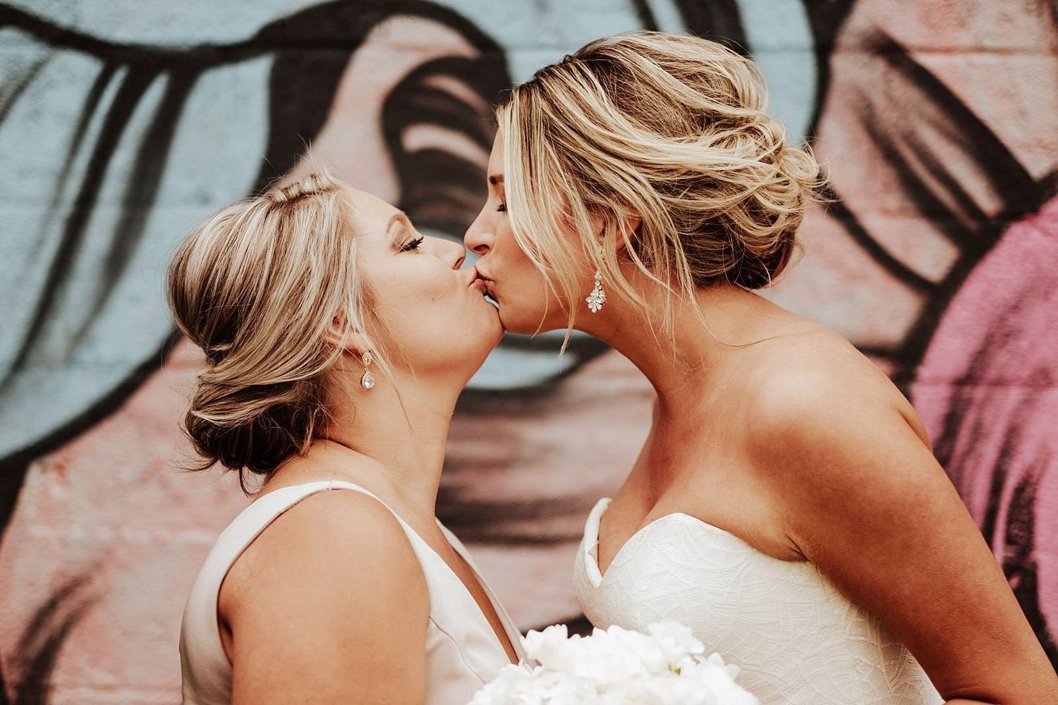 Emotional and fun interaction: Shannon kissing a bridesmaid during the wedding celebration