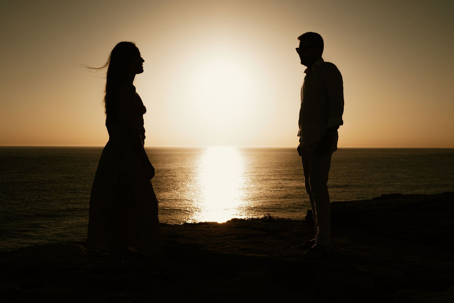 Contraluz documental de la pareja frente al horizonte oceánico Faro de Trafalgar Laura y Fernando Roberto Pecino
