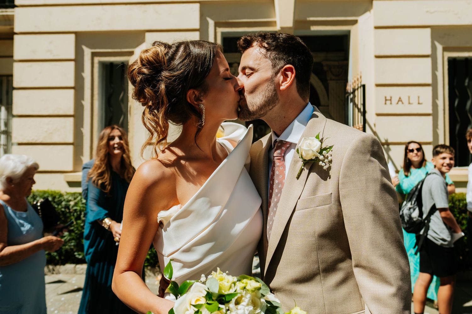 Sunny outdoor wedding moment captured against classic building architecture. Elopement in Gibraltar Roberto Pecino Photographer