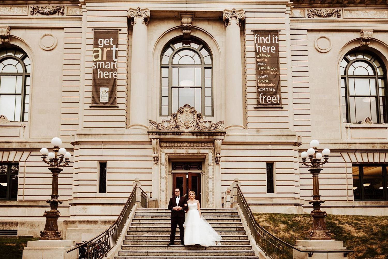 Elegant wedding couple on the grand City Hall staircase in downtown Grand Rapids.
