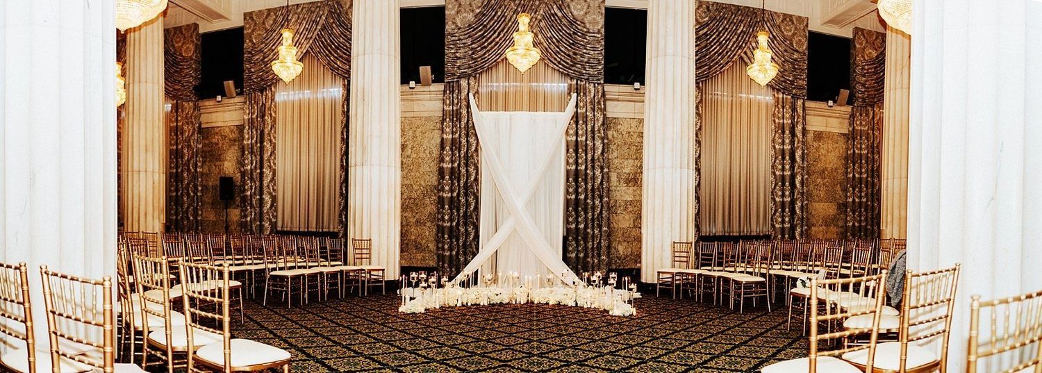 Panoramic view of The Ballroom at McKay ceremony setup with elegant chairs and candles