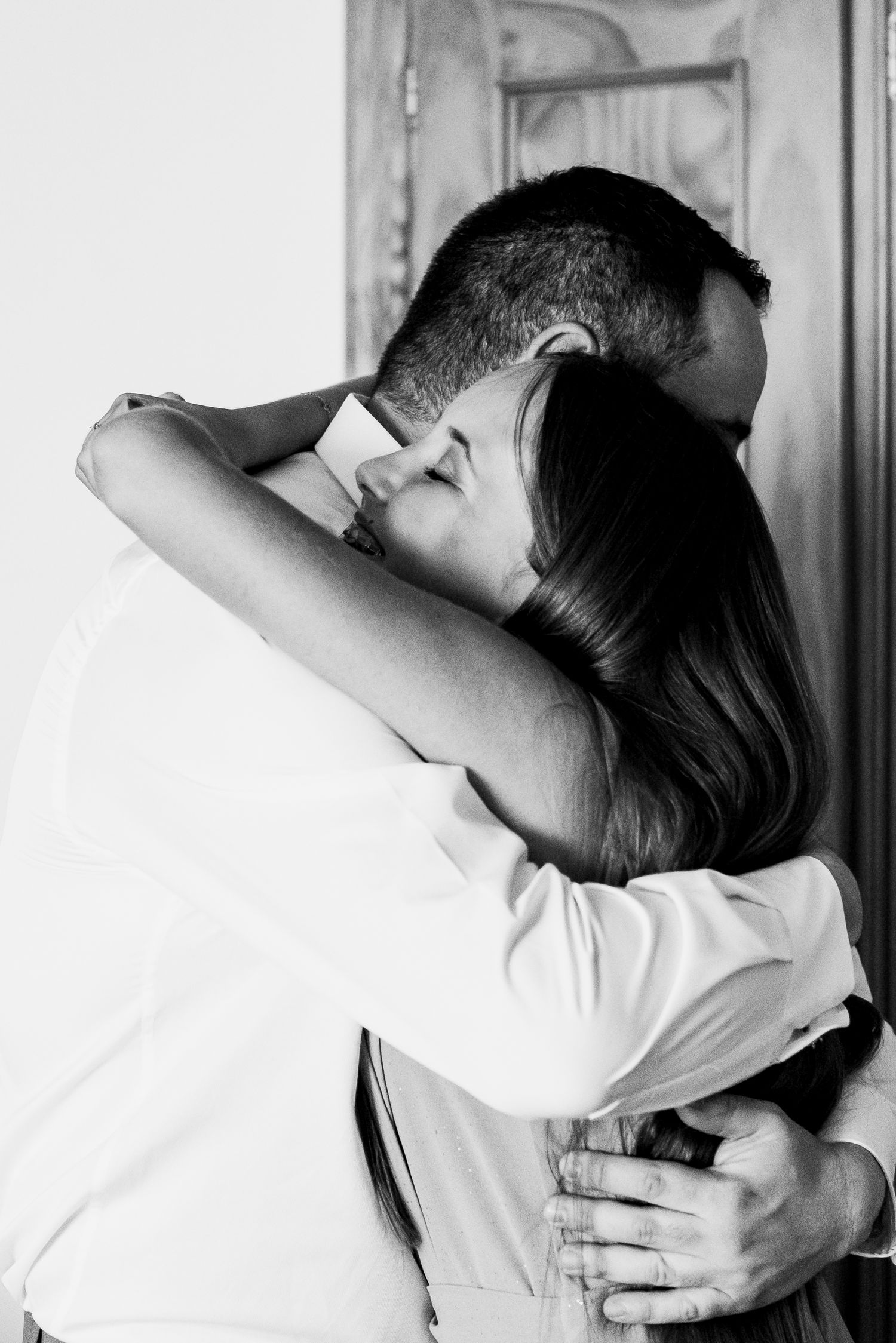 Black and white photo series showing an intimate embrace between two people.