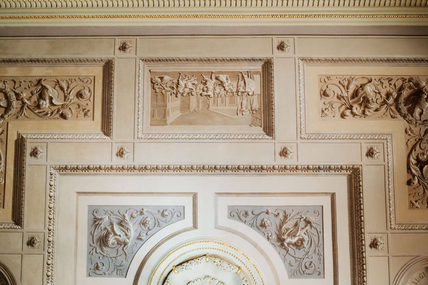 Elegant wedding venue interior with ornate architectural details and classical moldings along the walls and ceiling.