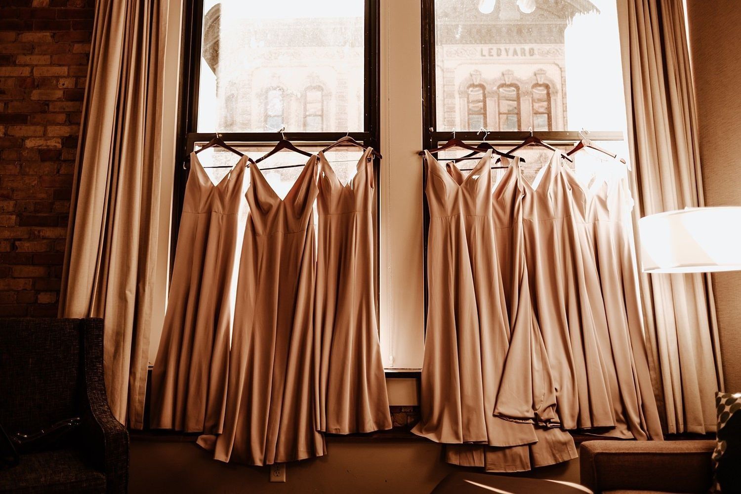 Bridesmaids' dresses displayed with urban city views at Amway Grand Plaza