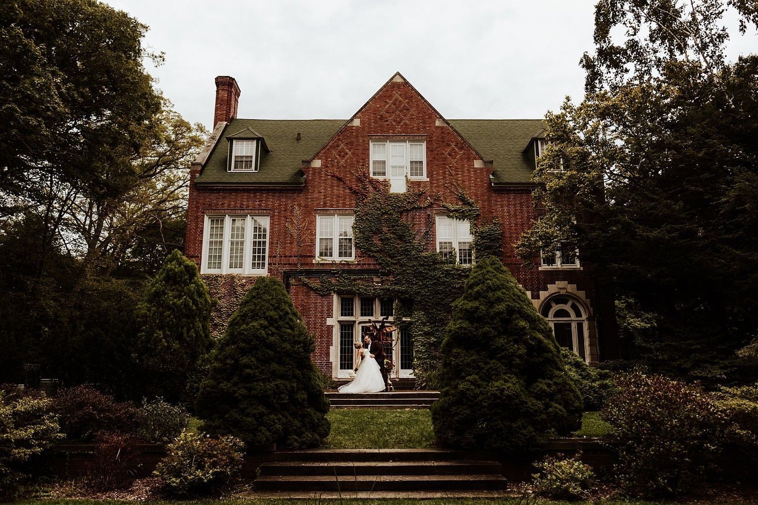 Artistic bridal portrait featuring Shannon and Karel with a scenic garden frame and architectural background. Grand Rapids photographer