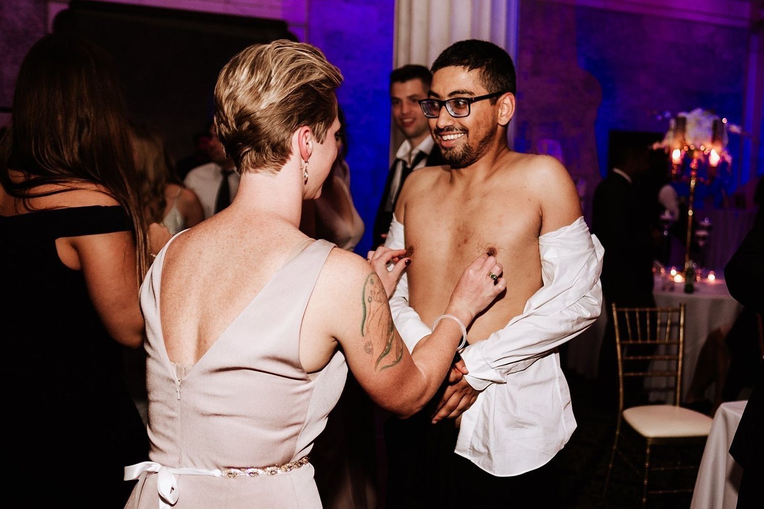 Wild wedding party moment: Shirtless guest celebrating on the dance floor in Grand Rapids