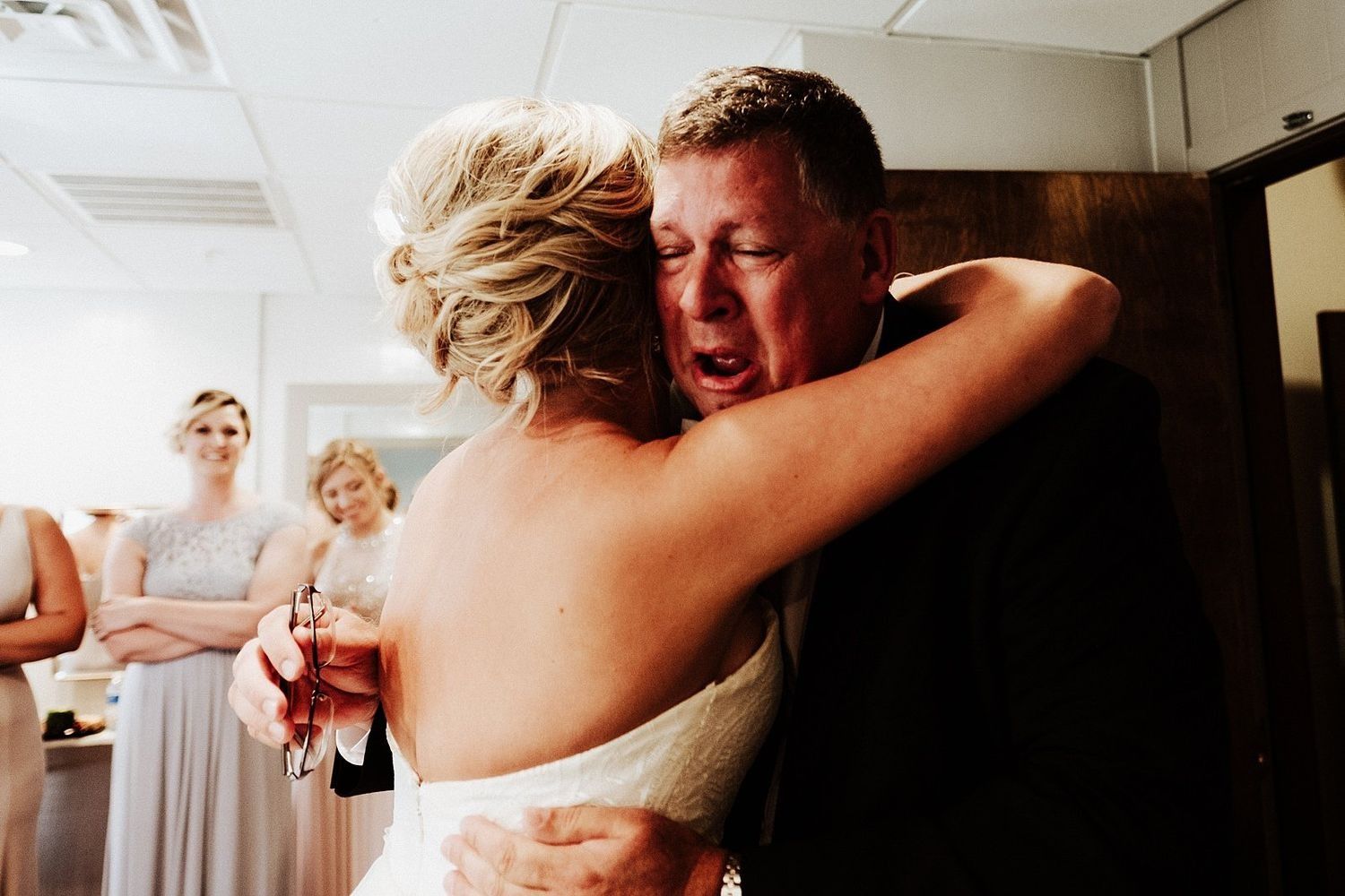 Tearful embrace between the father of the bride and Shannon in Grand Rapids