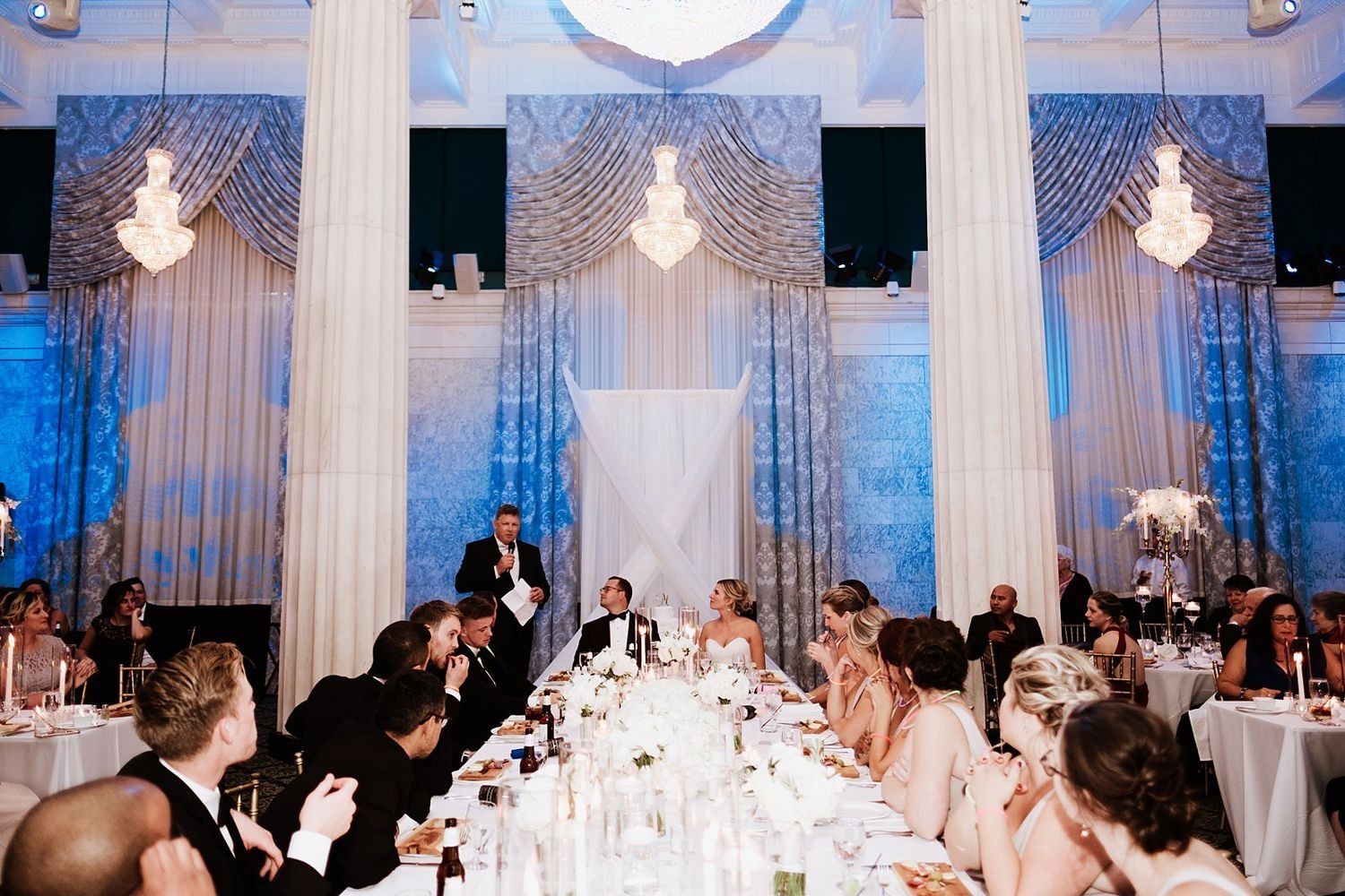 Breathtaking wide-angle shot of The Ballroom at McKay reception with luxury decor and warm lighting.