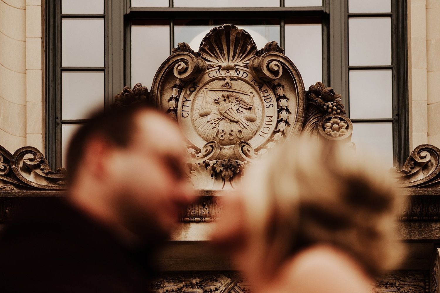 Shannon and Karel posing by the official City Hall crest in Grand Rapids, Michigan.
