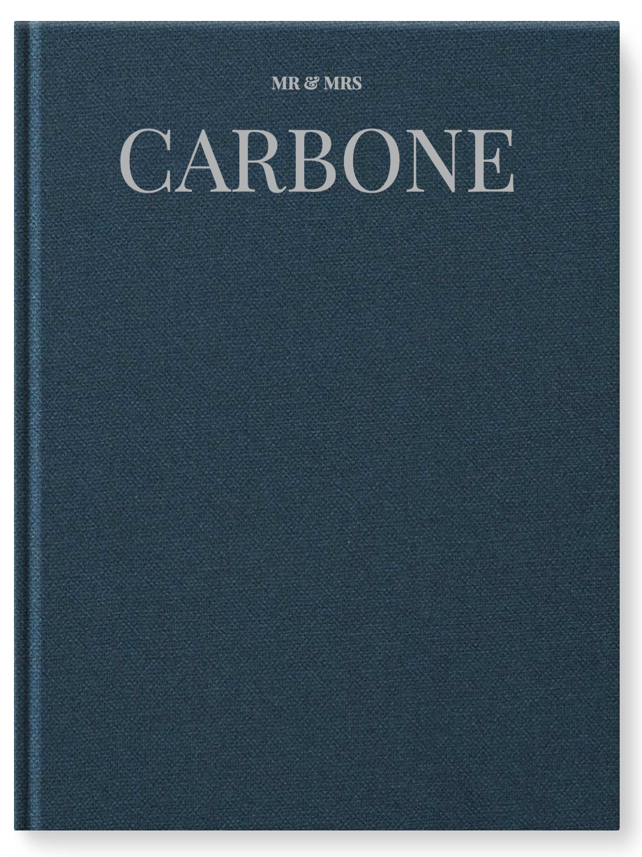 Navy blue linen hardcover wedding guest book with silver text reading Mr & Mrs Carbone on the front cover.
