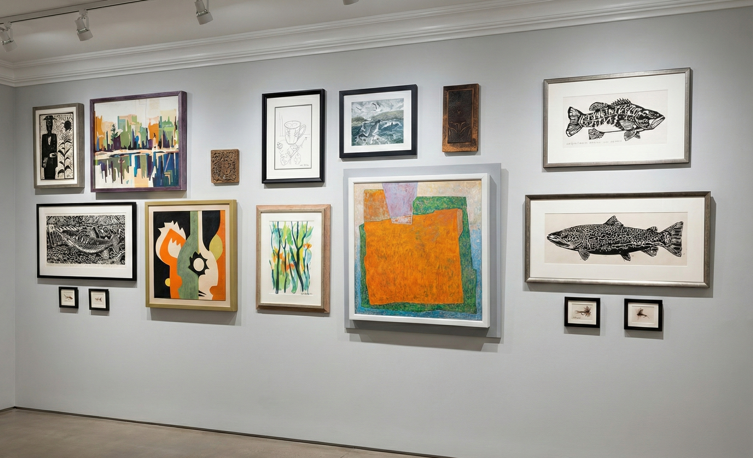 Art gallery wall displaying a collection of framed artwork including paintings, prints and photographs in various sizes.