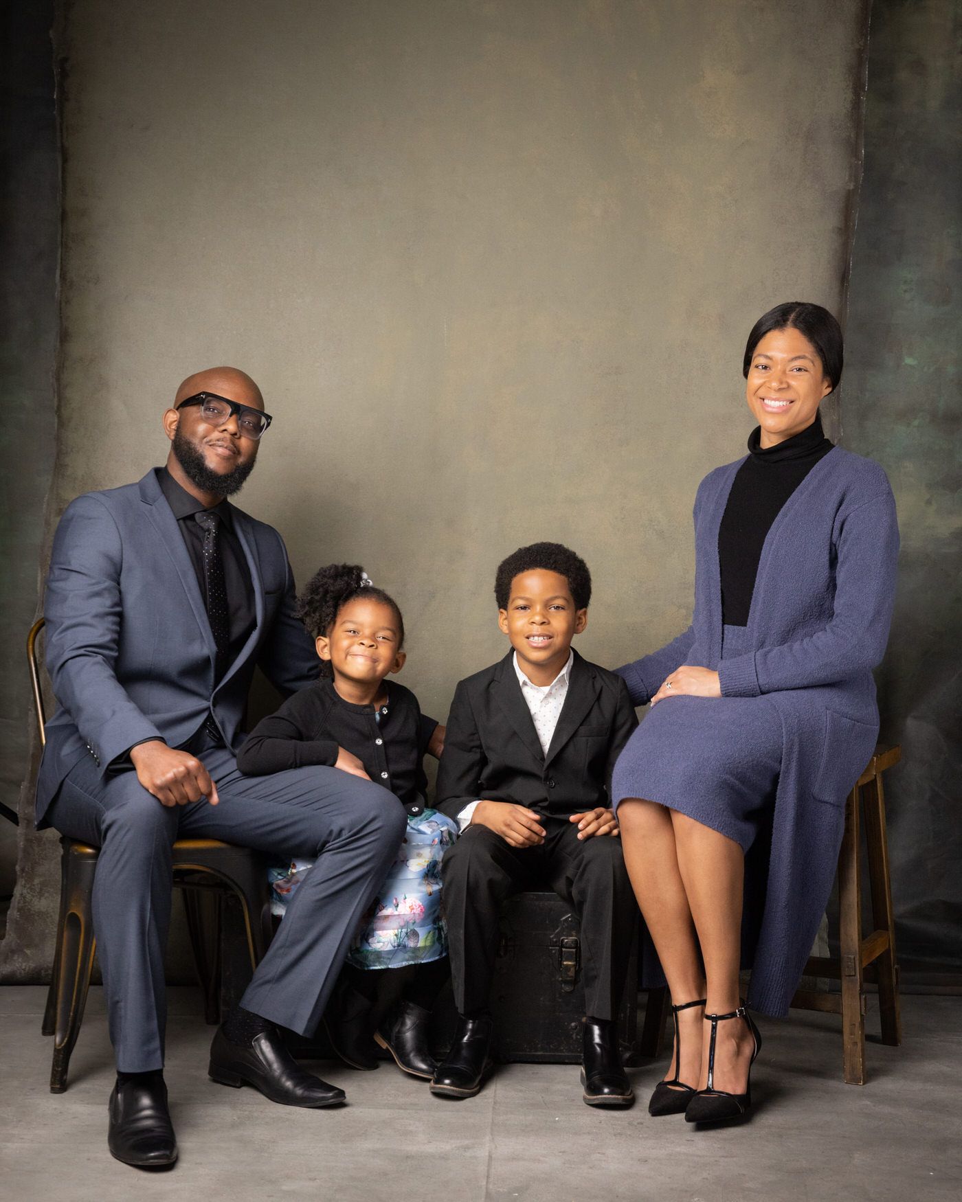A series of artistic black and white portraits showing adults and children in formal attire sitting together on a studio bench.