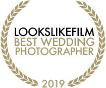 Three golden laurel wreath award badges for Best Wedding Photographer 2019 from Lookslikefilm arranged in a row.