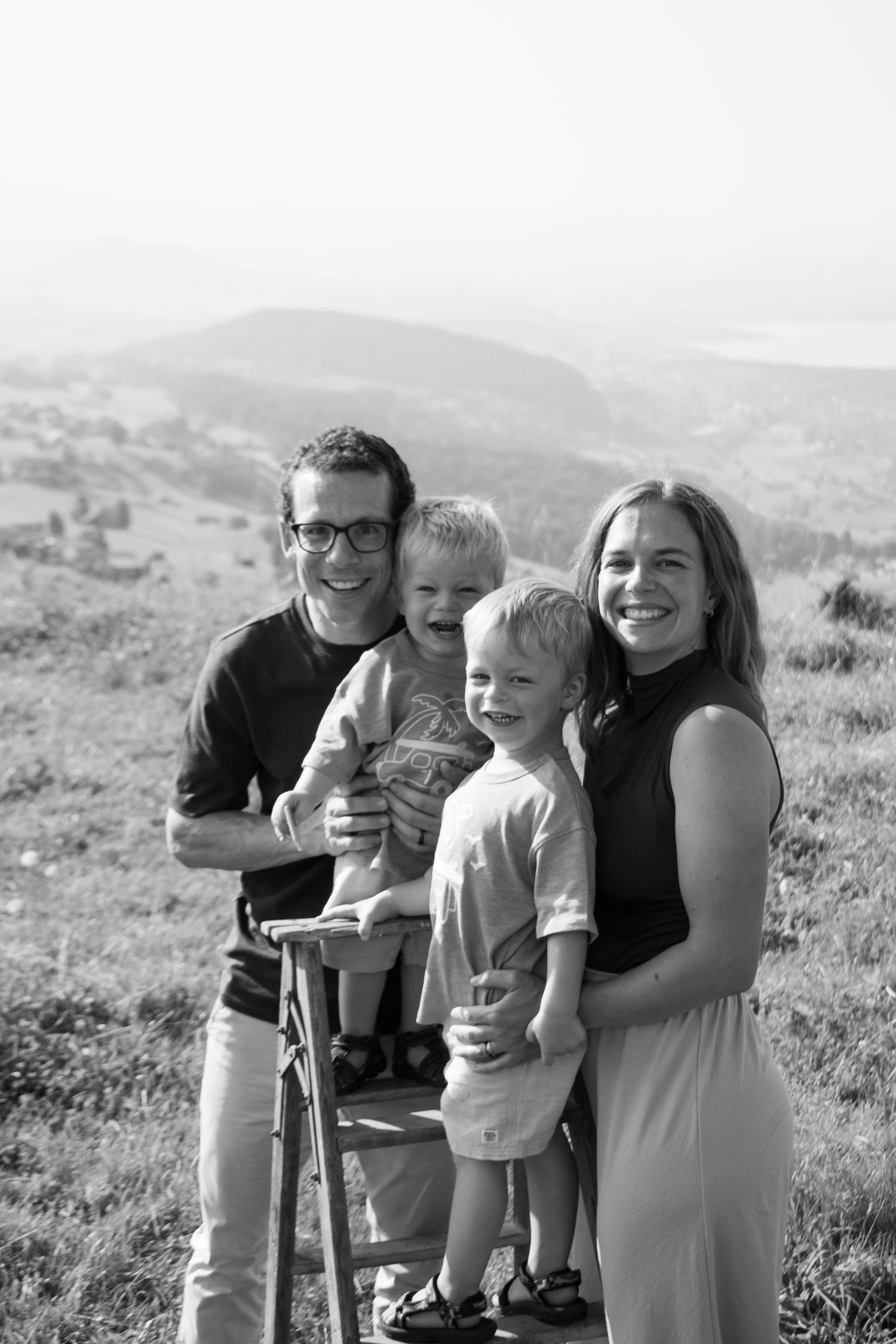 Family portrait sequence showing loving moments outdoors against a mountain backdrop.