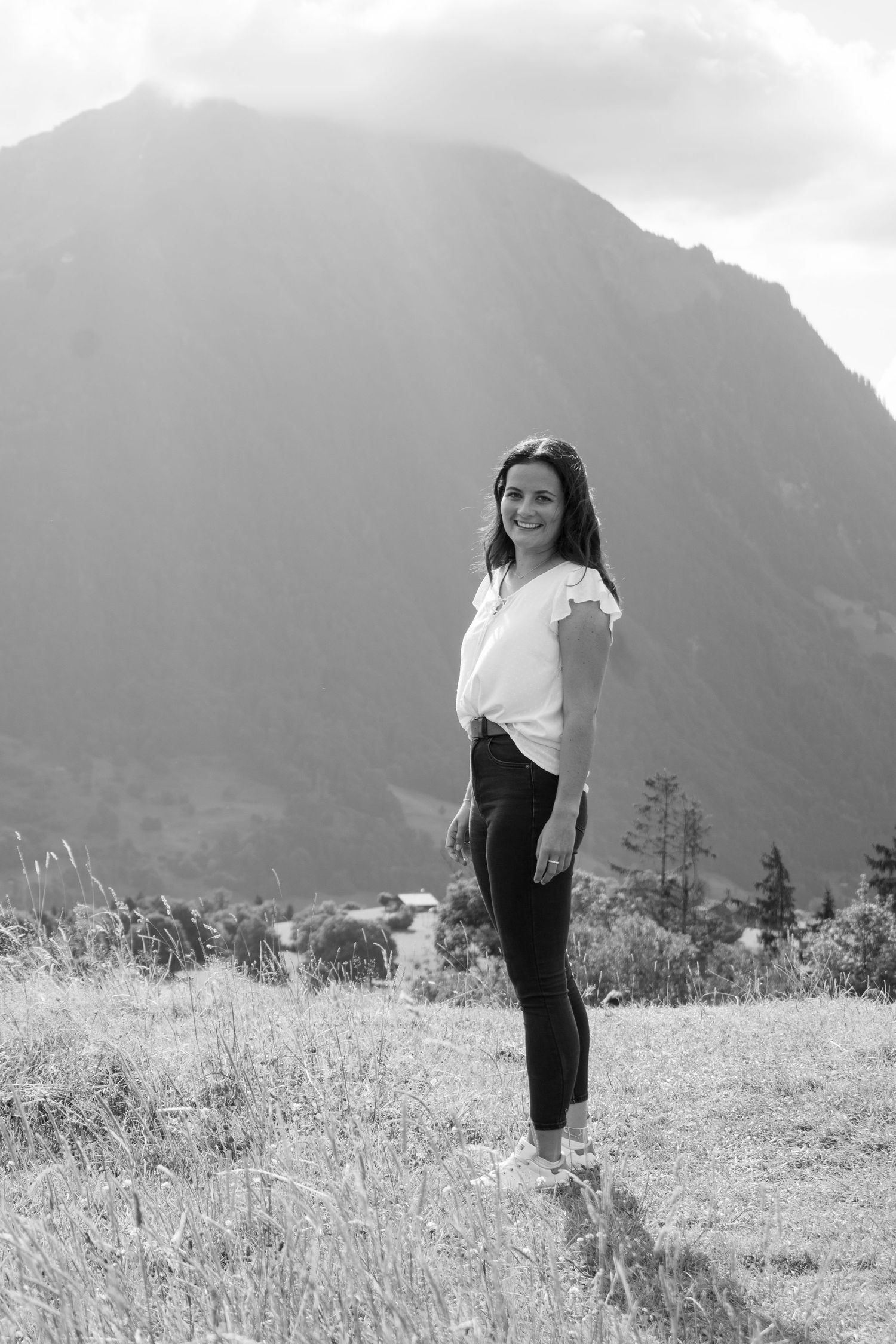 Black and white sequence of playful poses in a mountain meadow.