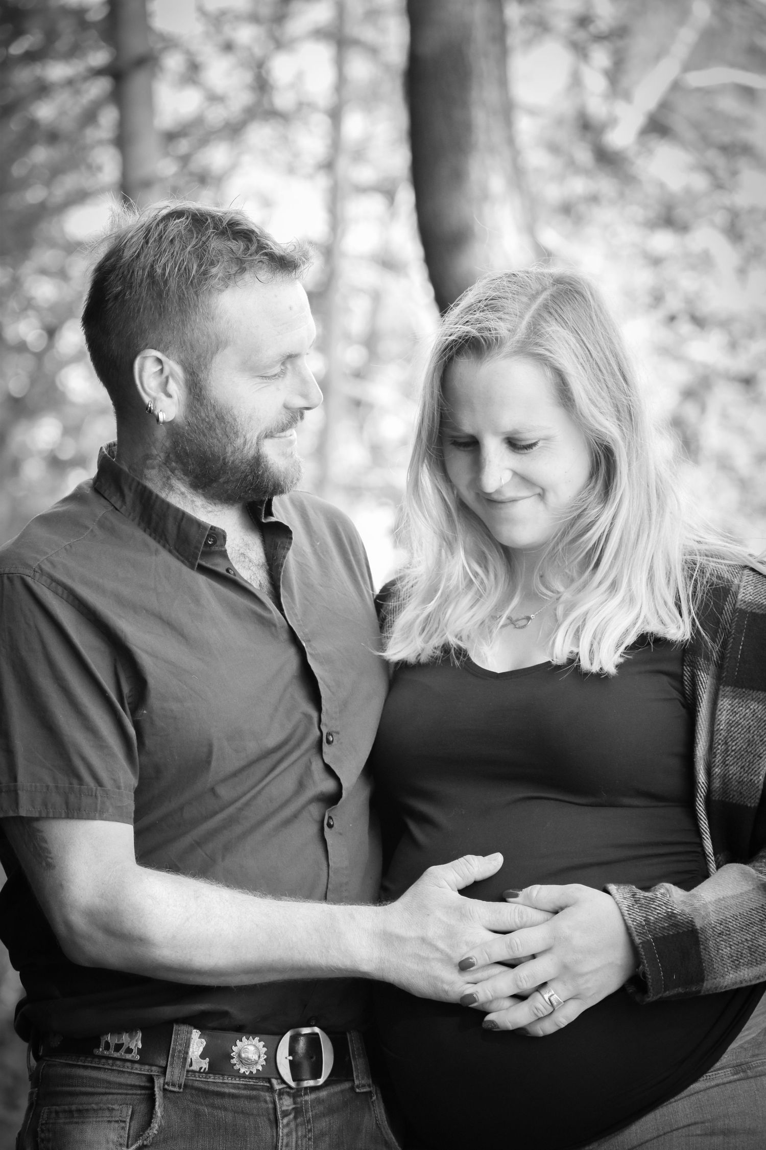 Intimate black and white portrait session showing tender moments between couple.