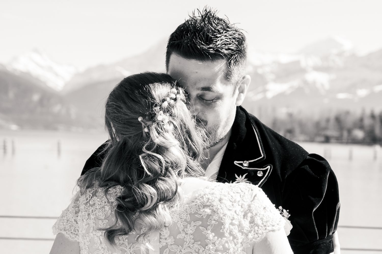 A black and white wedding photo montage showing romantic moments between a couple in various outdoor settings.