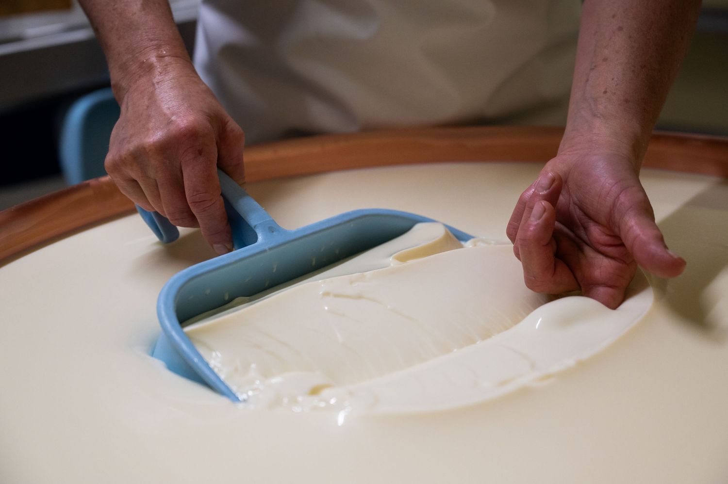 A series of hands demonstrating the process of cutting and preparing dough on a white surface.