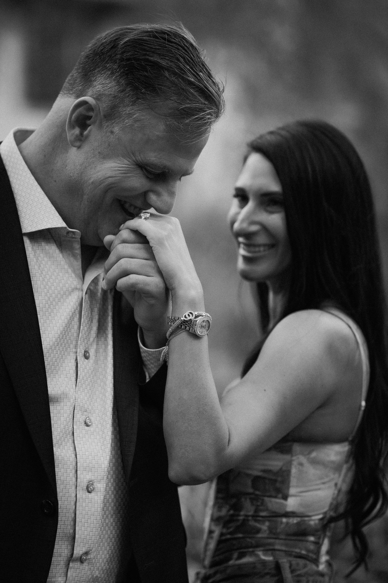 Black and white photo capturing intimate laughing moments between a couple.