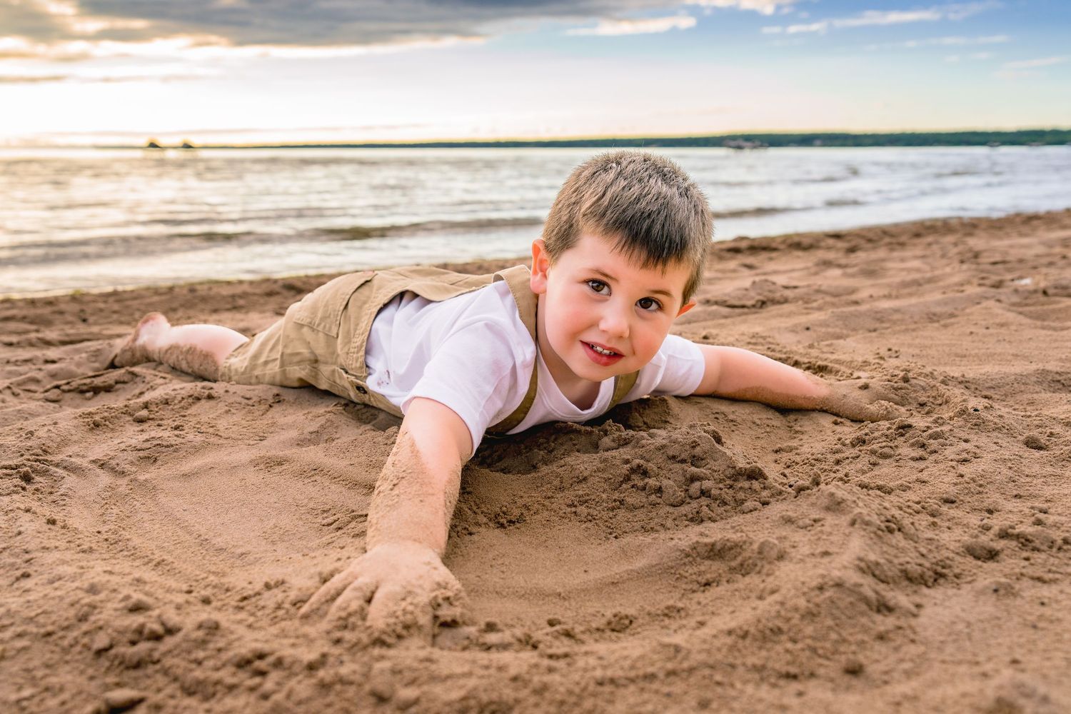 A sequence of photos shows someone lying on a sandy beach and gradually being covered by incoming waves.