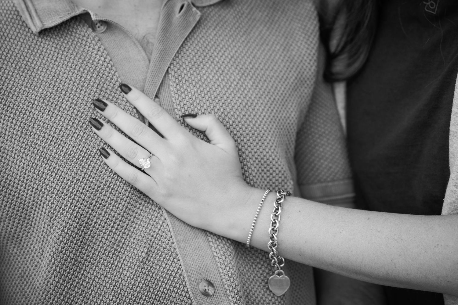 Black and white photo series showing close-up details of hands wearing jewelry and rings.