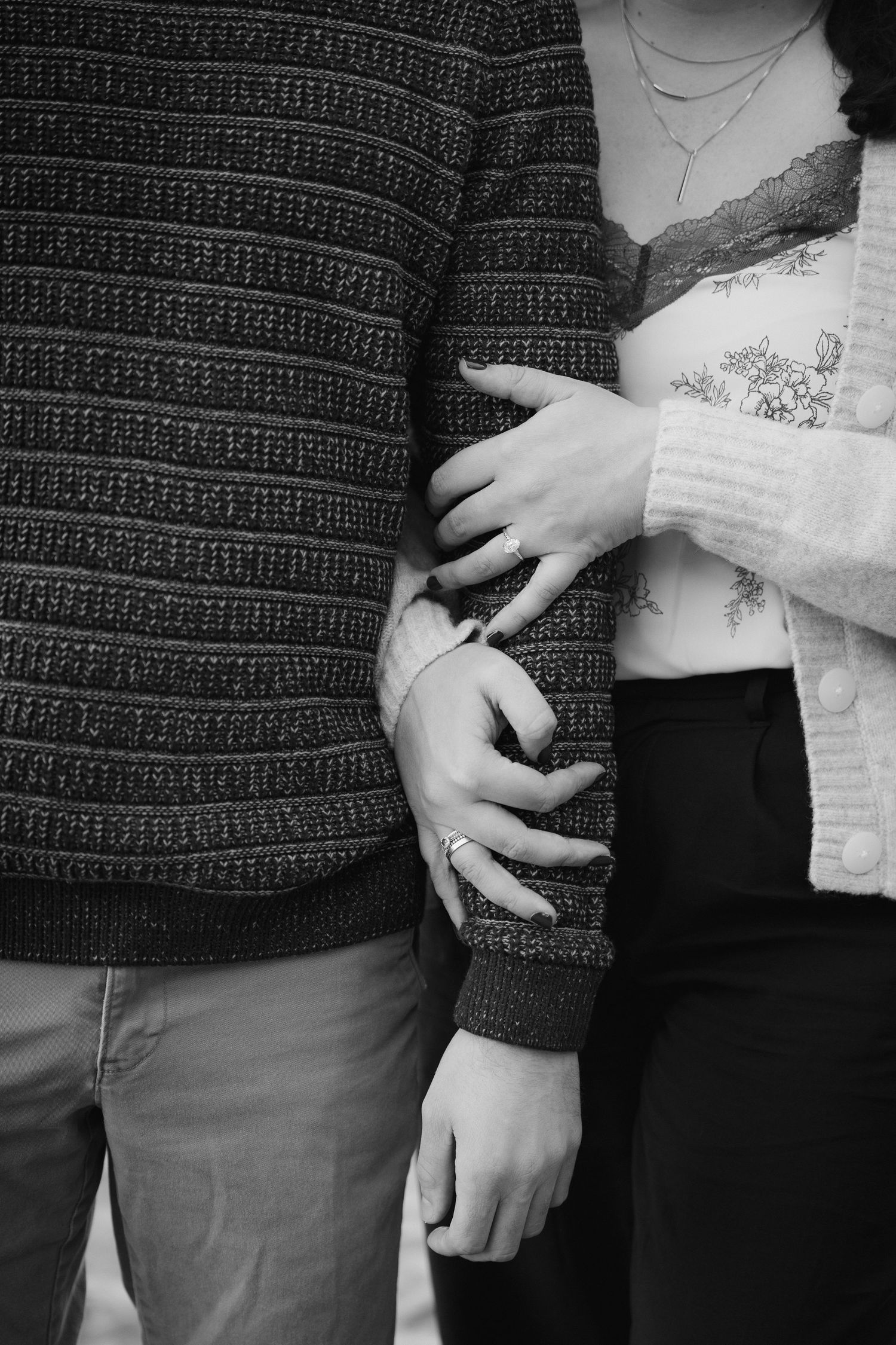 Close-up shots showing hands and torsos of a couple wearing coordinating sweaters and casual attire.