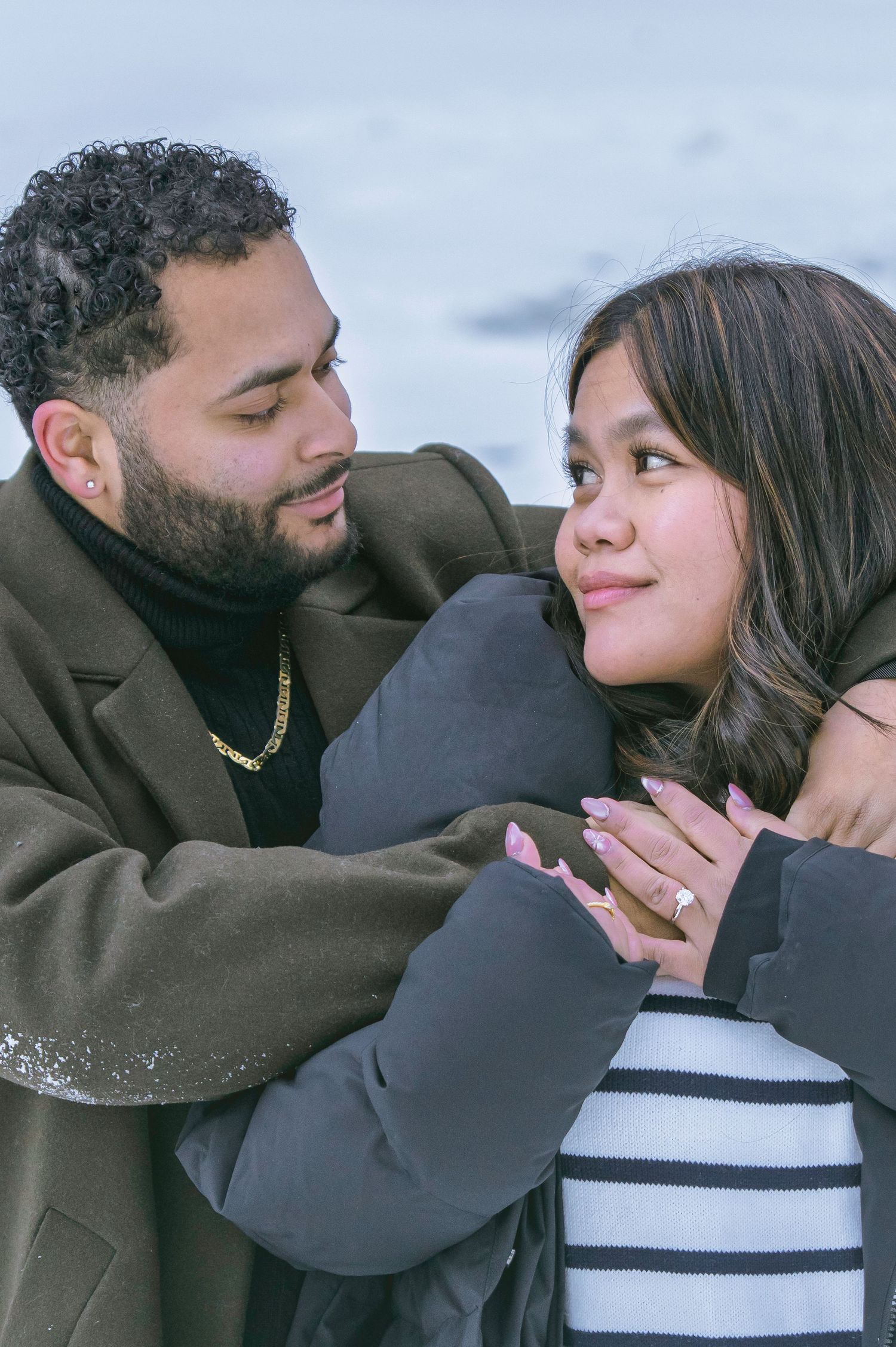 A couple shares an intimate moment on a couch in a series of four progressive photos.