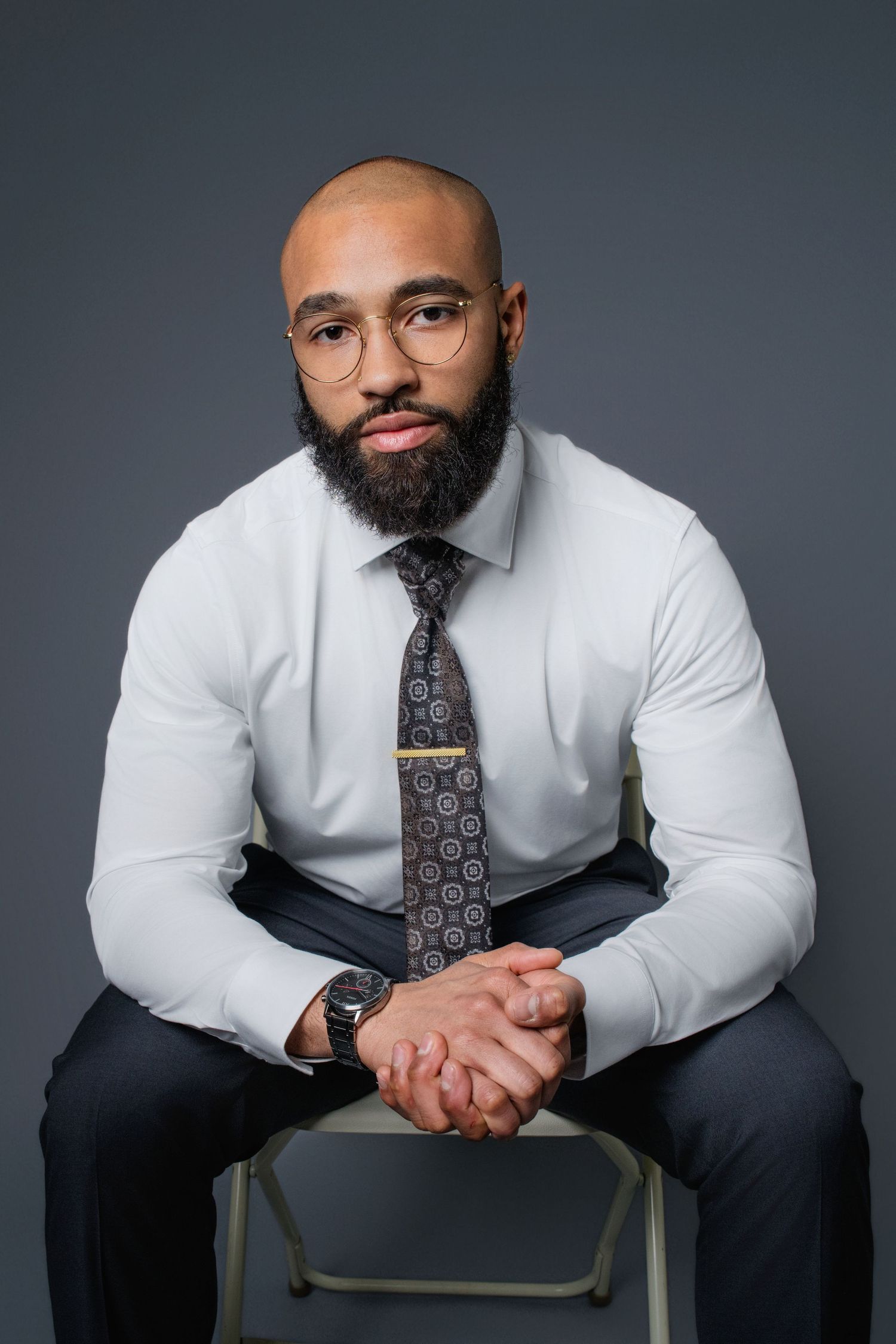 Professional studio portrait series showing a person in a white dress shirt and patterned tie. Branding and headshot photos