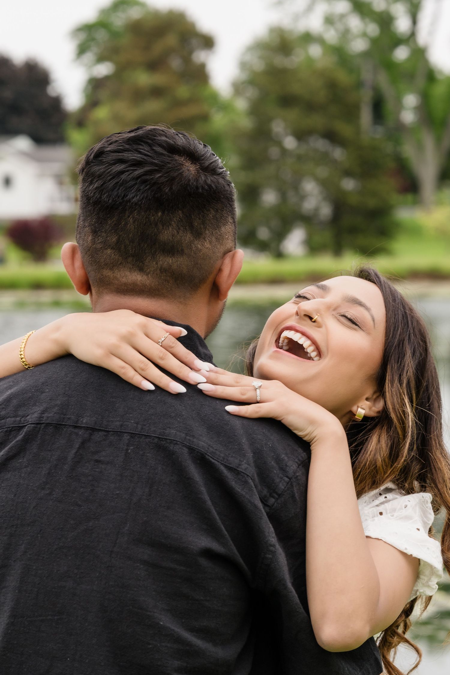A joyful embrace captured during a romantic outdoor moment.