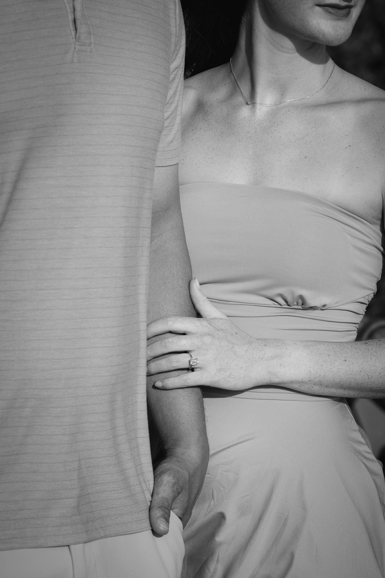 A black and white series of cropped photos showing a person wearing a light-colored dress against a textured background.